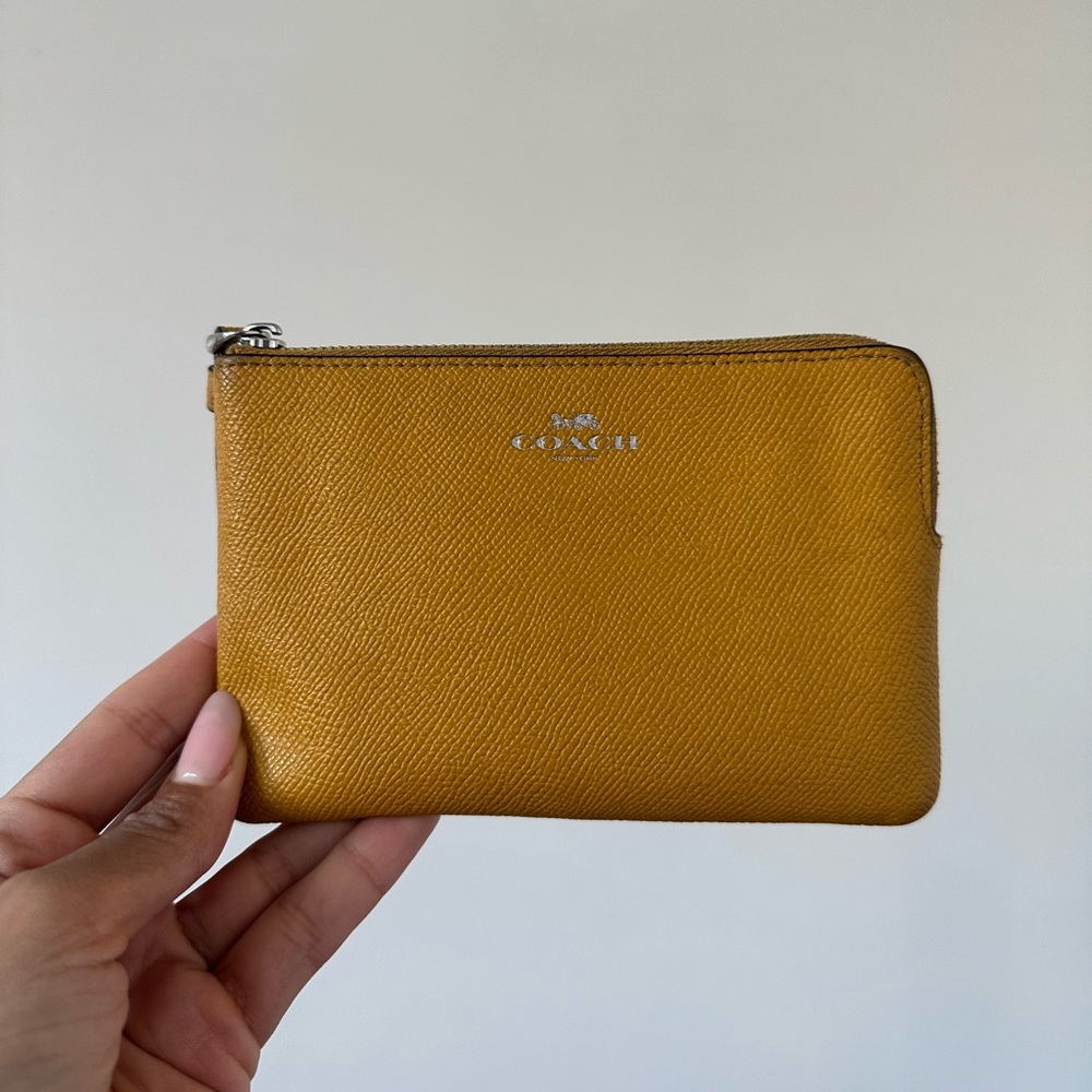 Coach wristlet in mustard colour